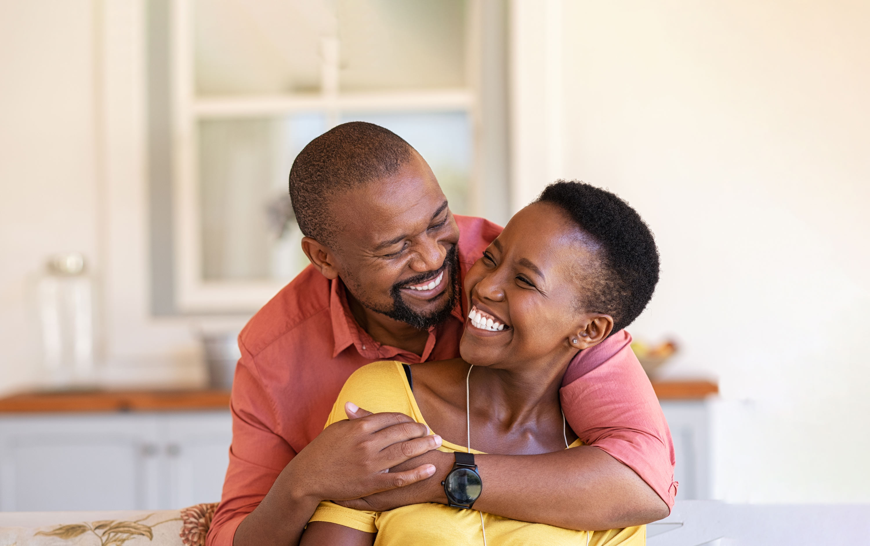 a couple with beautiful smiles embracing