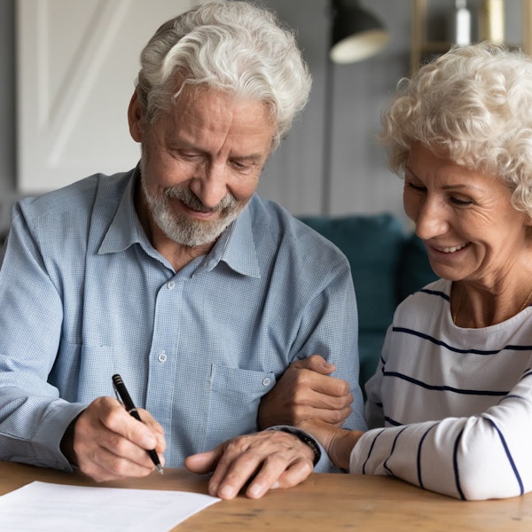 Mature couple signing a trust