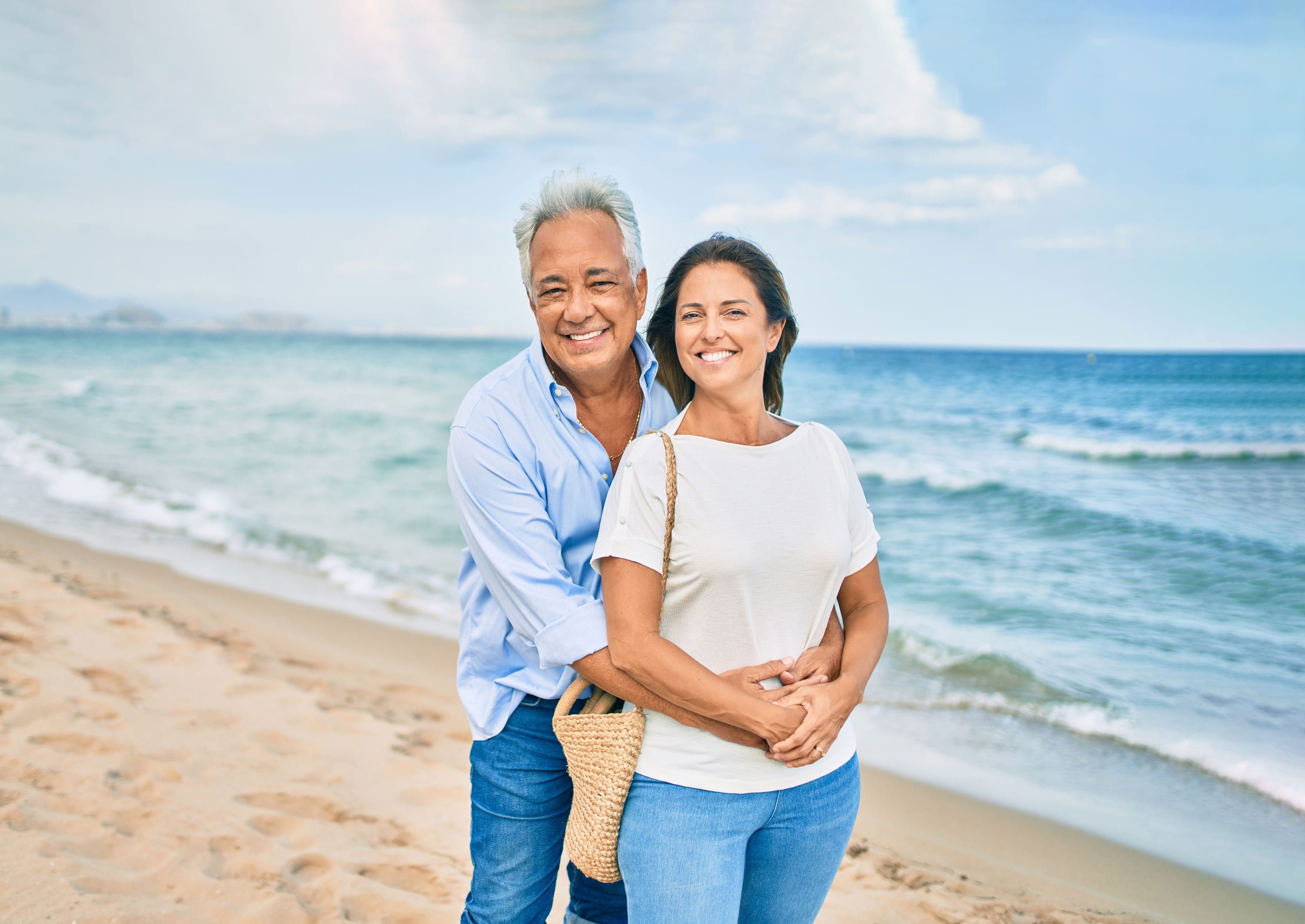 Smiling man and woman hugging each other