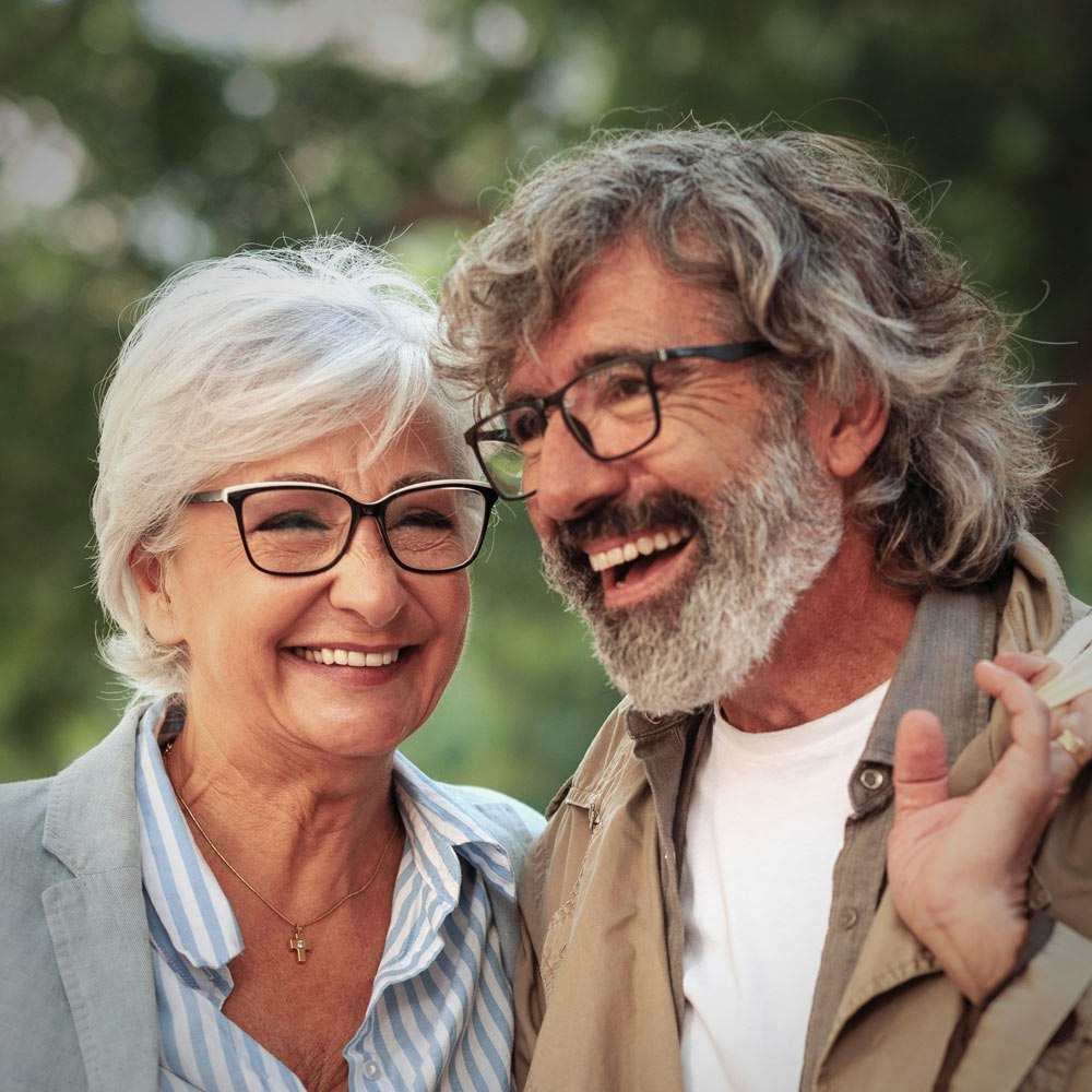 Smiling elderly woman with a smile makeover and partner