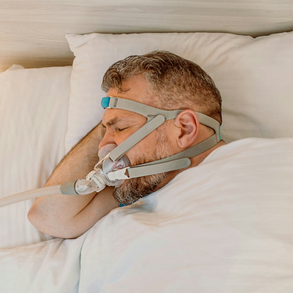 Man wearing a CPAP machine