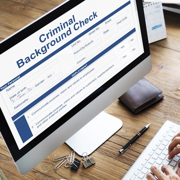 Worker doing criminal background check on computer