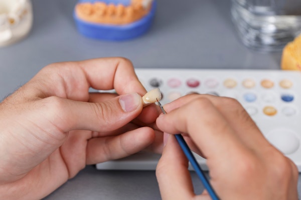 Ceramist creating a dental crown
