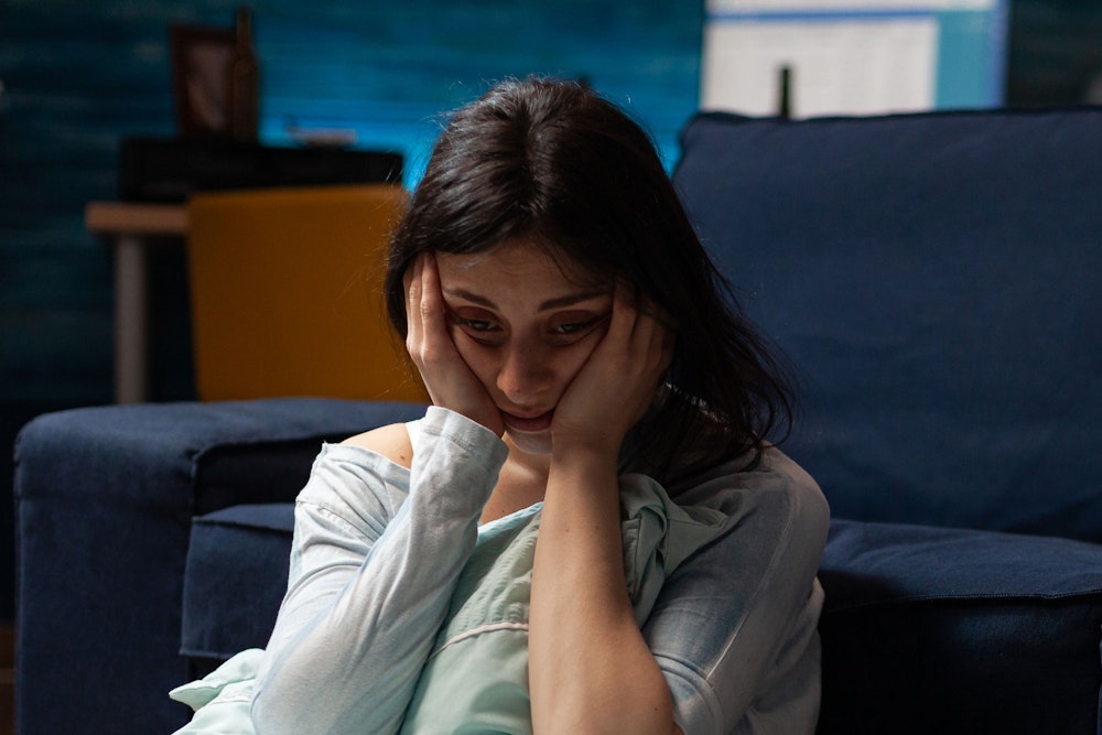 Crying woman holding her head