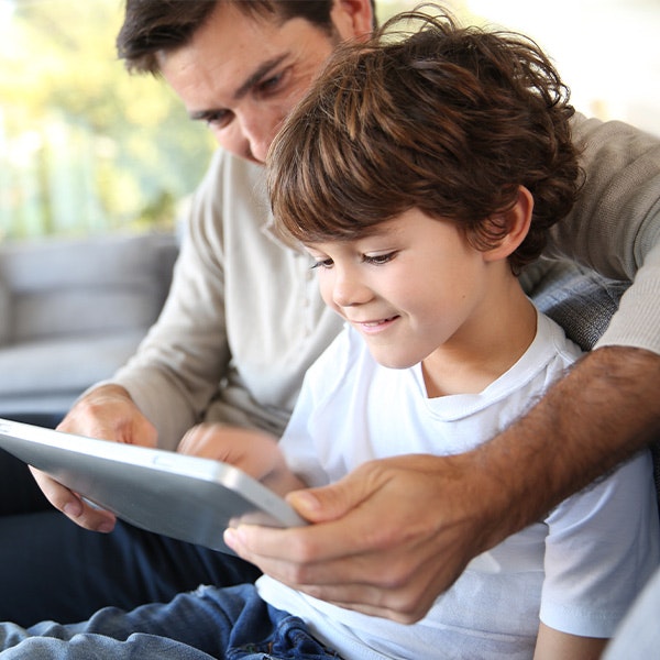 dad and son watching video on tablet