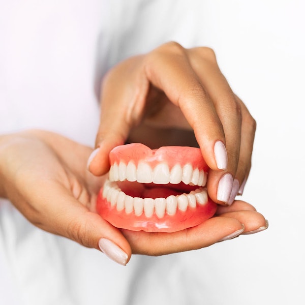 Denture in hand