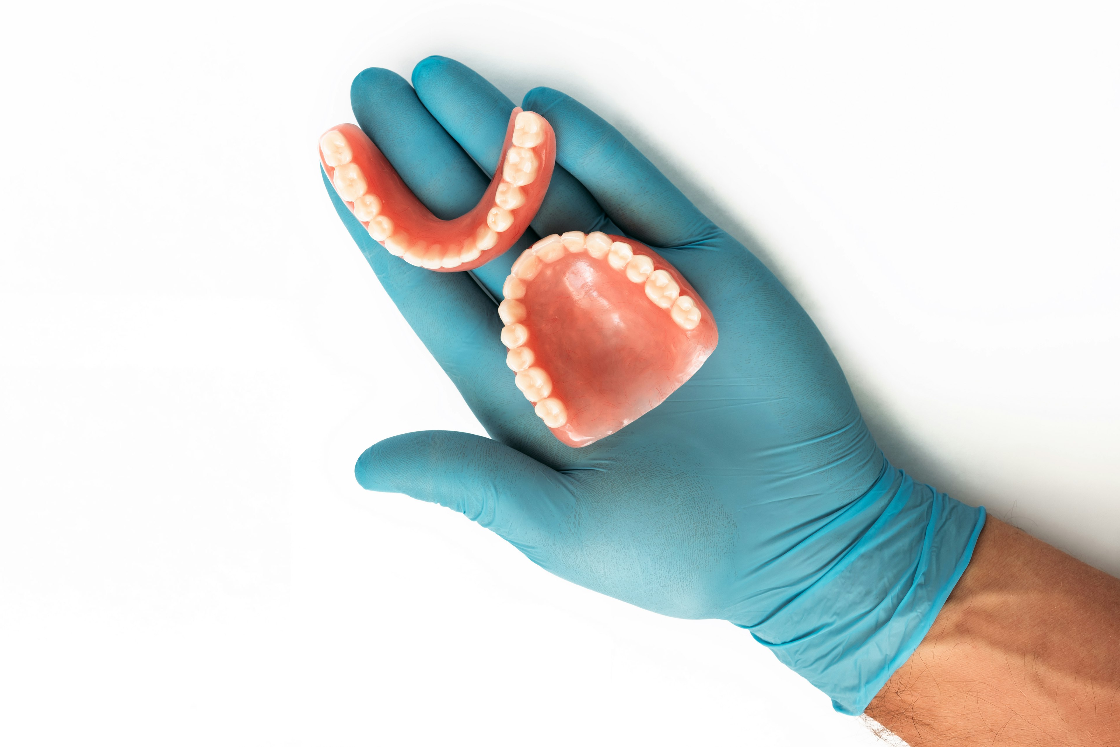 Aerial view of a person holding dentures in hand