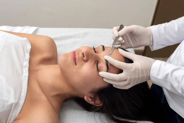 Woman getting dermaplaning