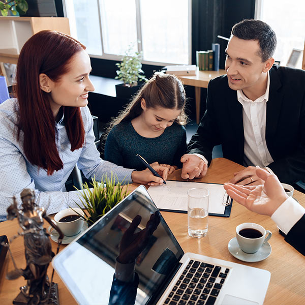 Couple and child signing legal documents