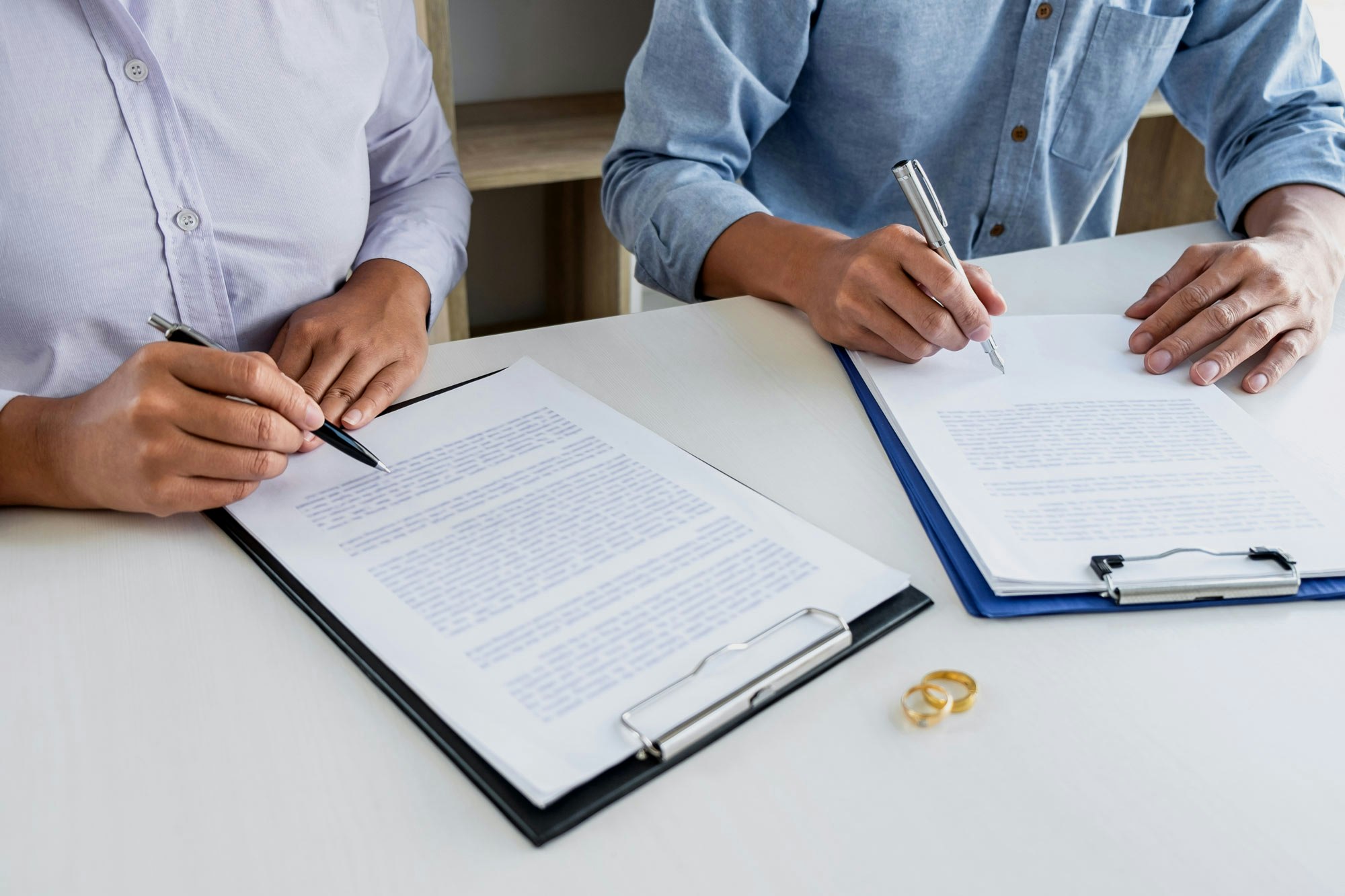 Couple signing postnuptial agreement