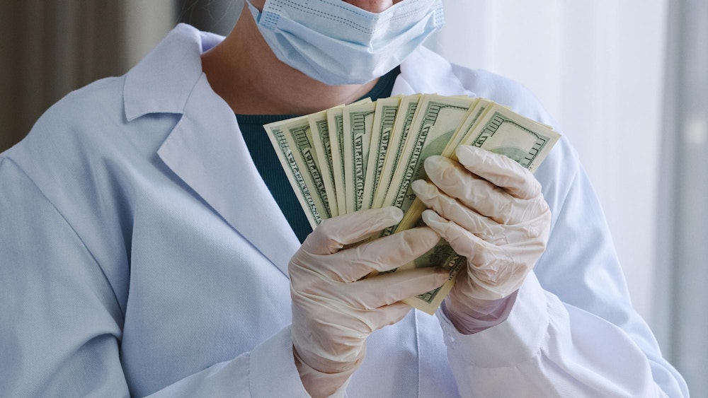 Medical professional holding money