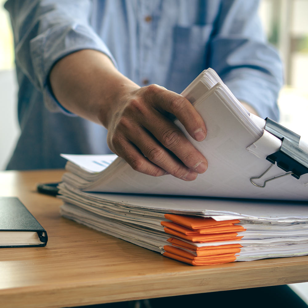 man reaching for documents as evidence