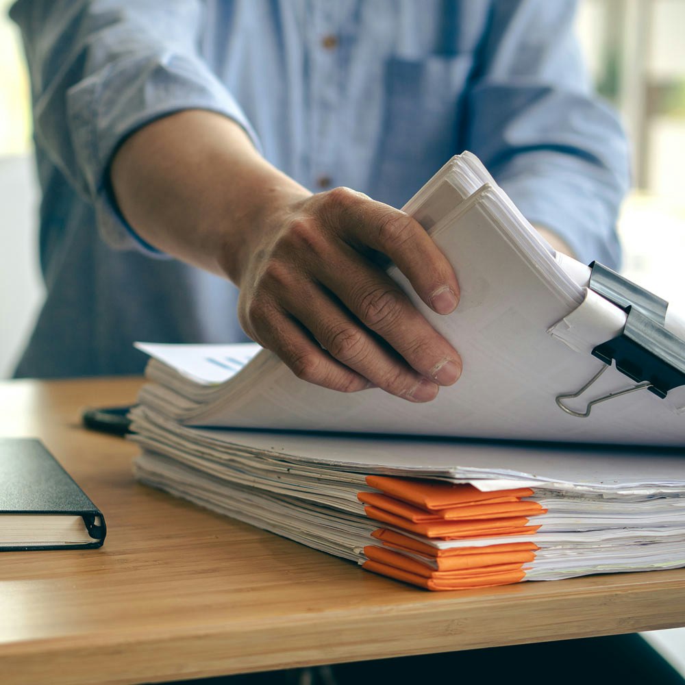 man reaching for documents as evidence