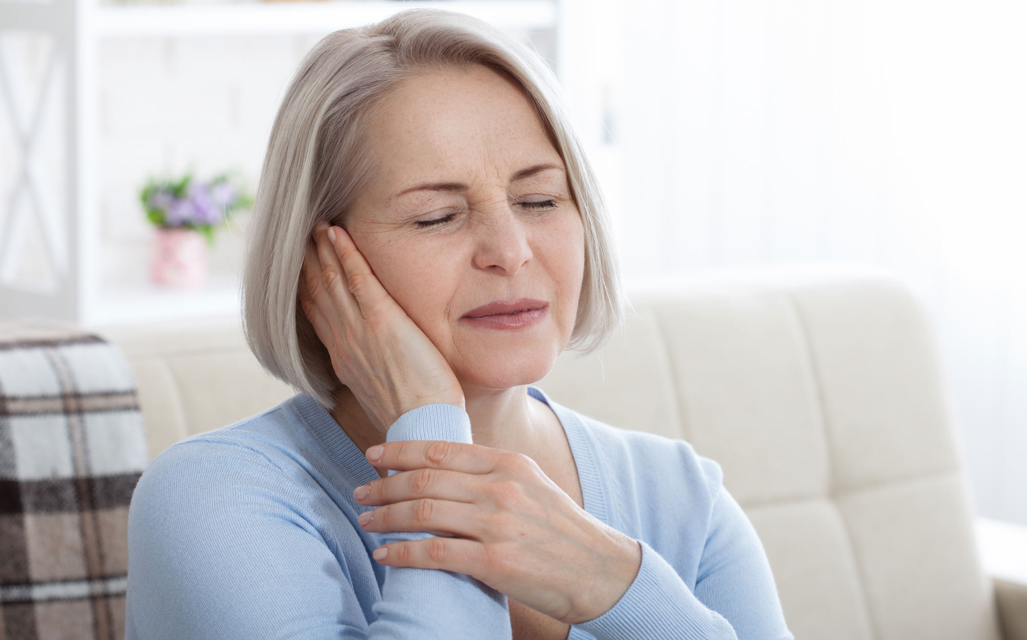 Woman suffering from tooth sensitivity