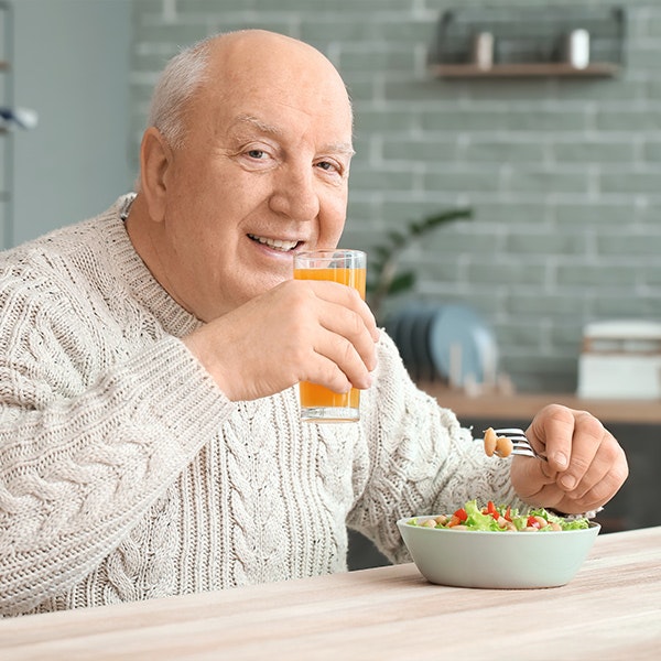 Mature man eating salad