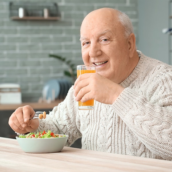 Older man eating salad