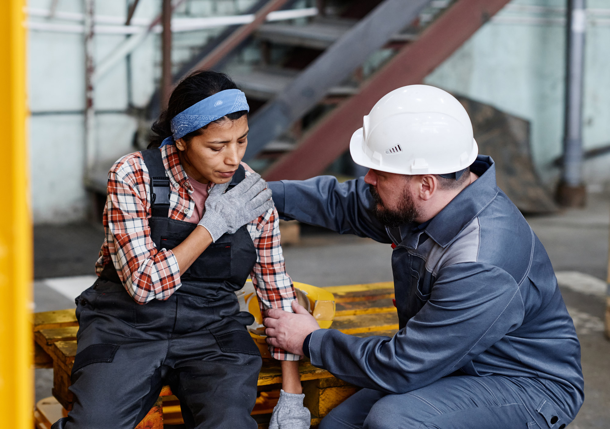Man helping injured female worker
