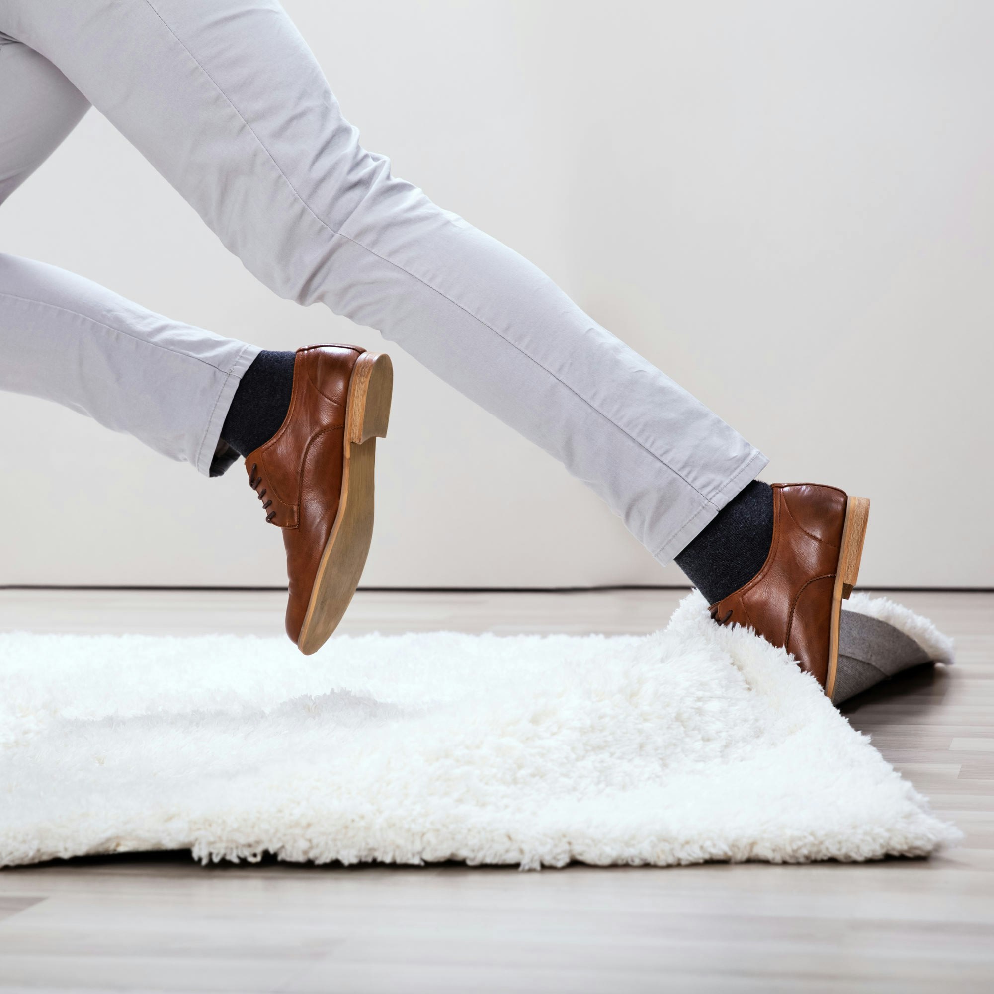 Man tripping over a work carpet