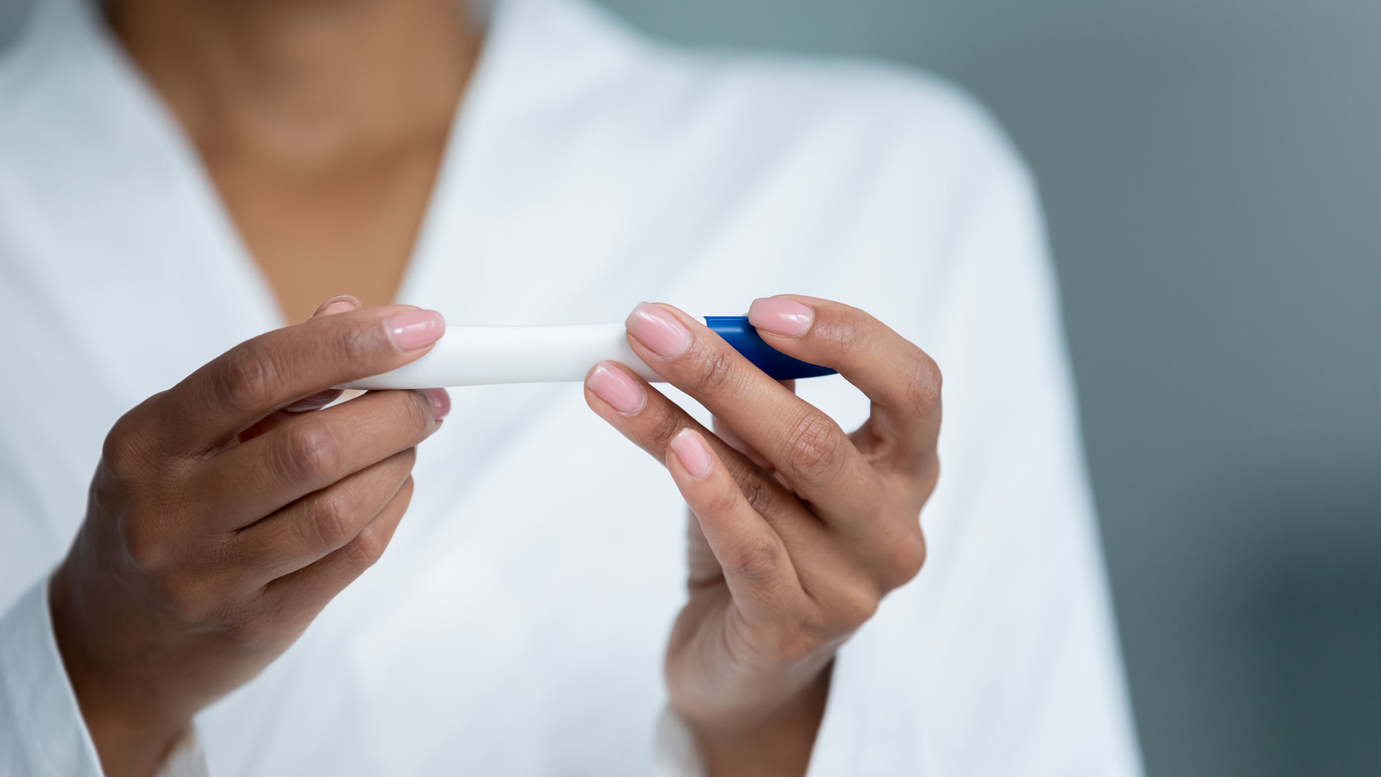 Woman holding fertility test in hands