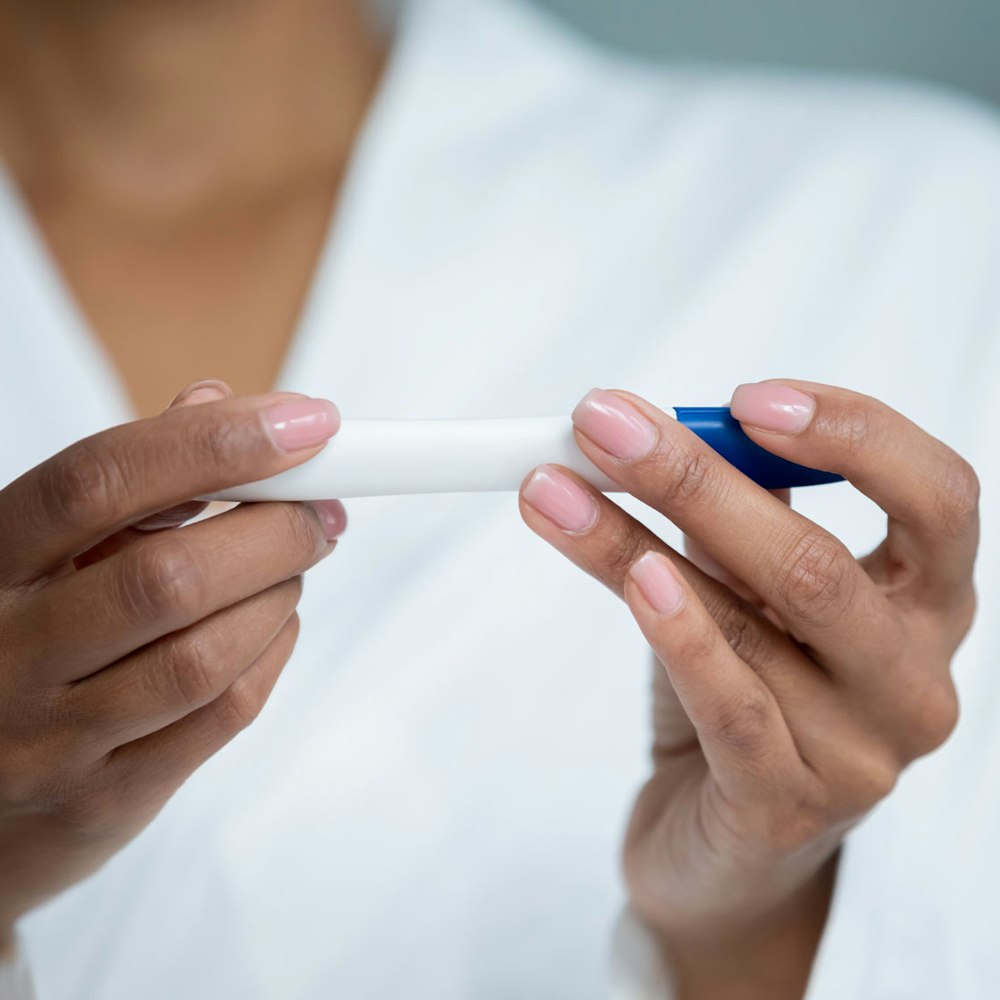 Woman holding fertility test in hands