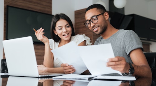 couple looking over paper bills