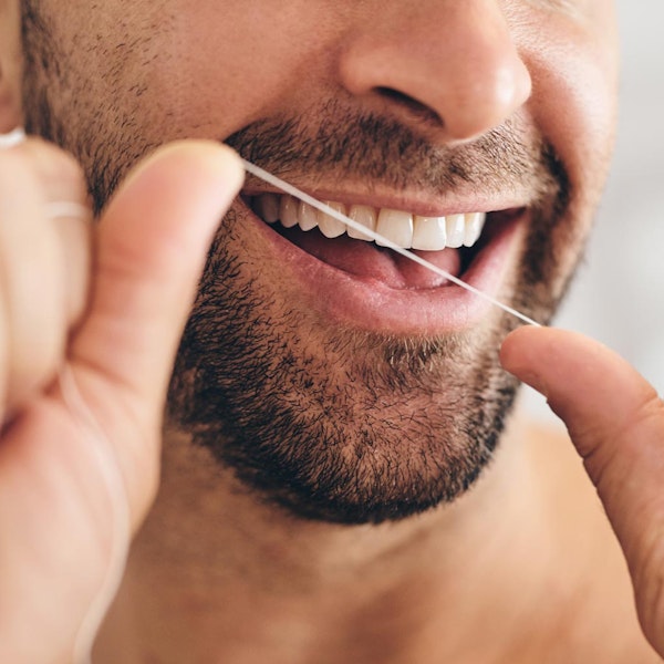Man flossing teeth