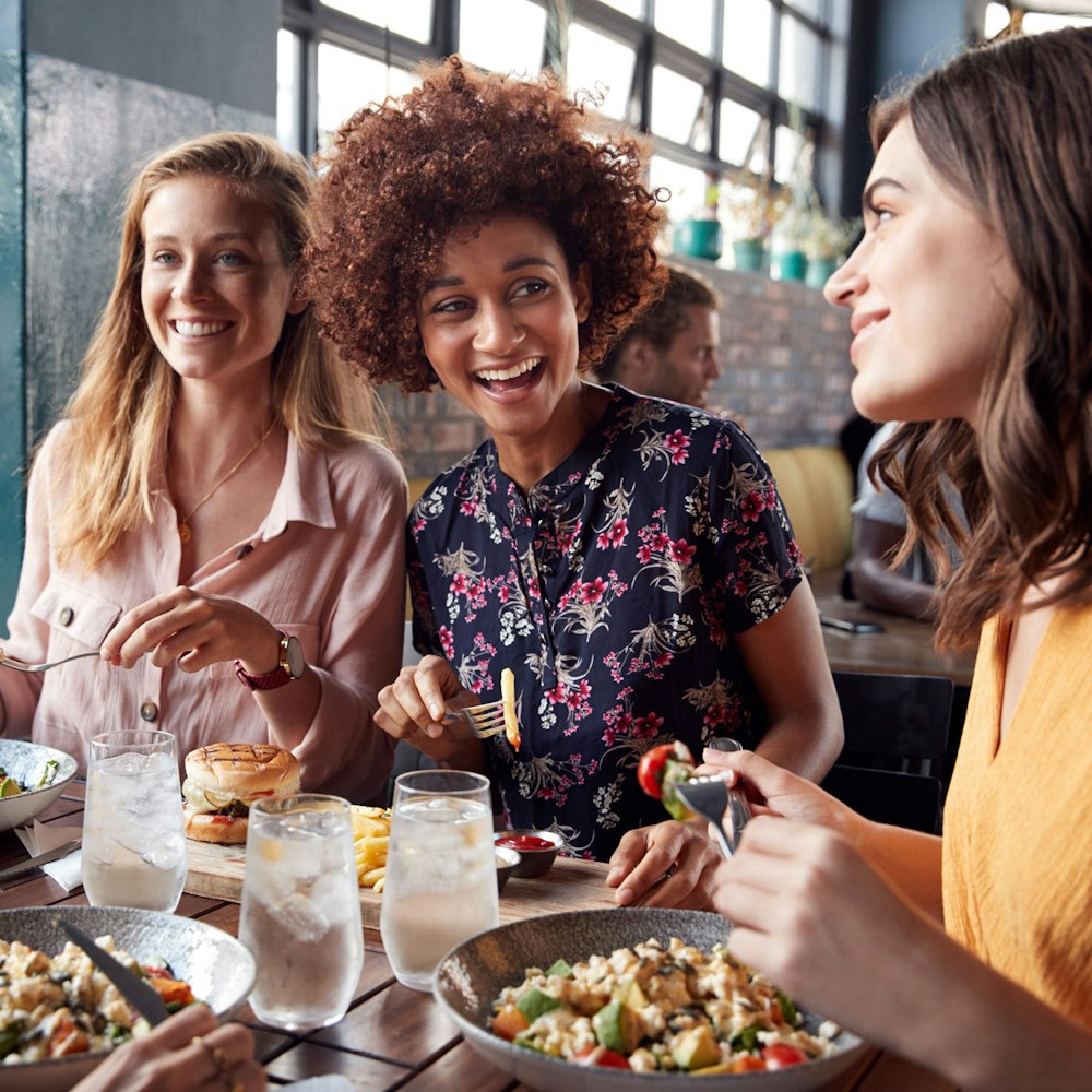 Three woman eating and talking together