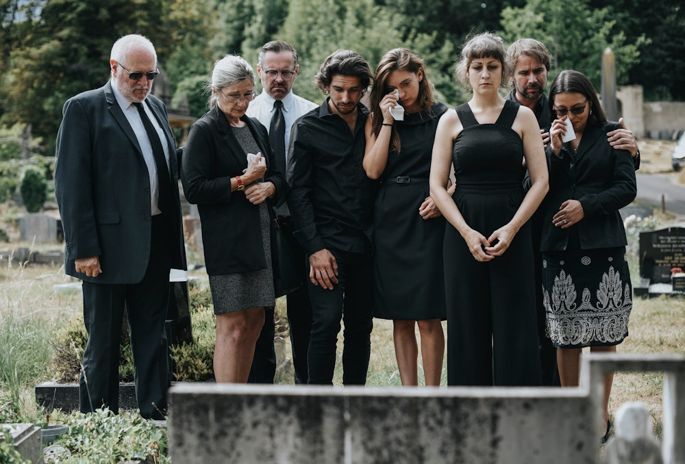 Family members mourning at gravesite