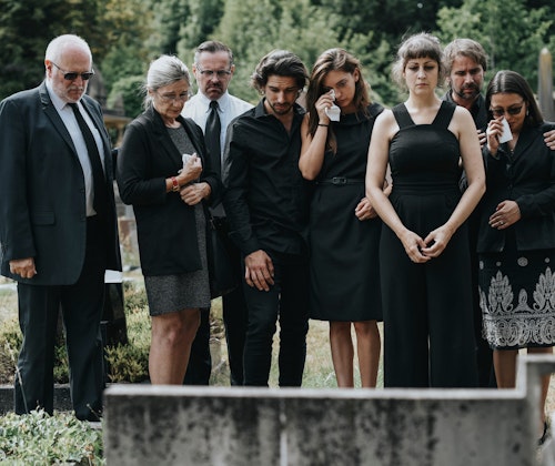 Family members mourning at gravesite