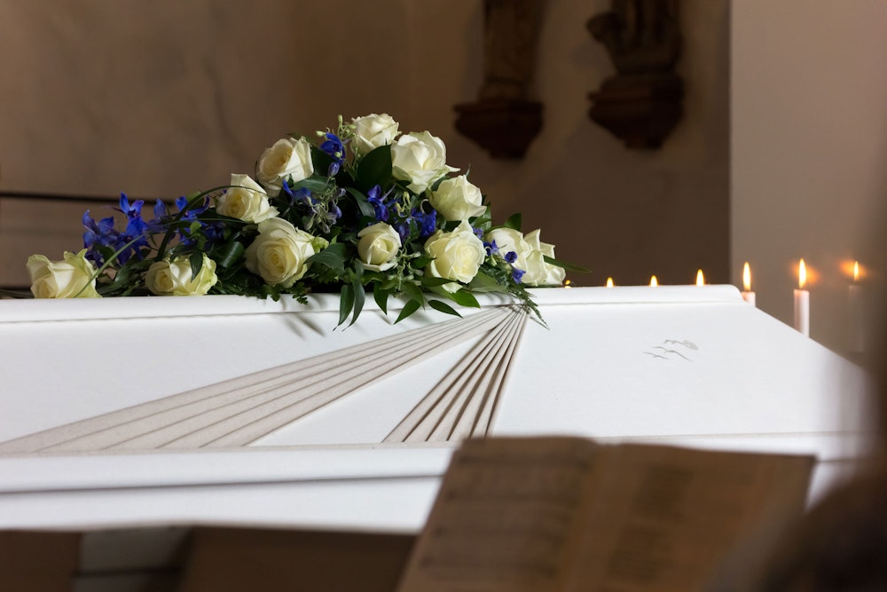 Casket with yellow and blue flowers