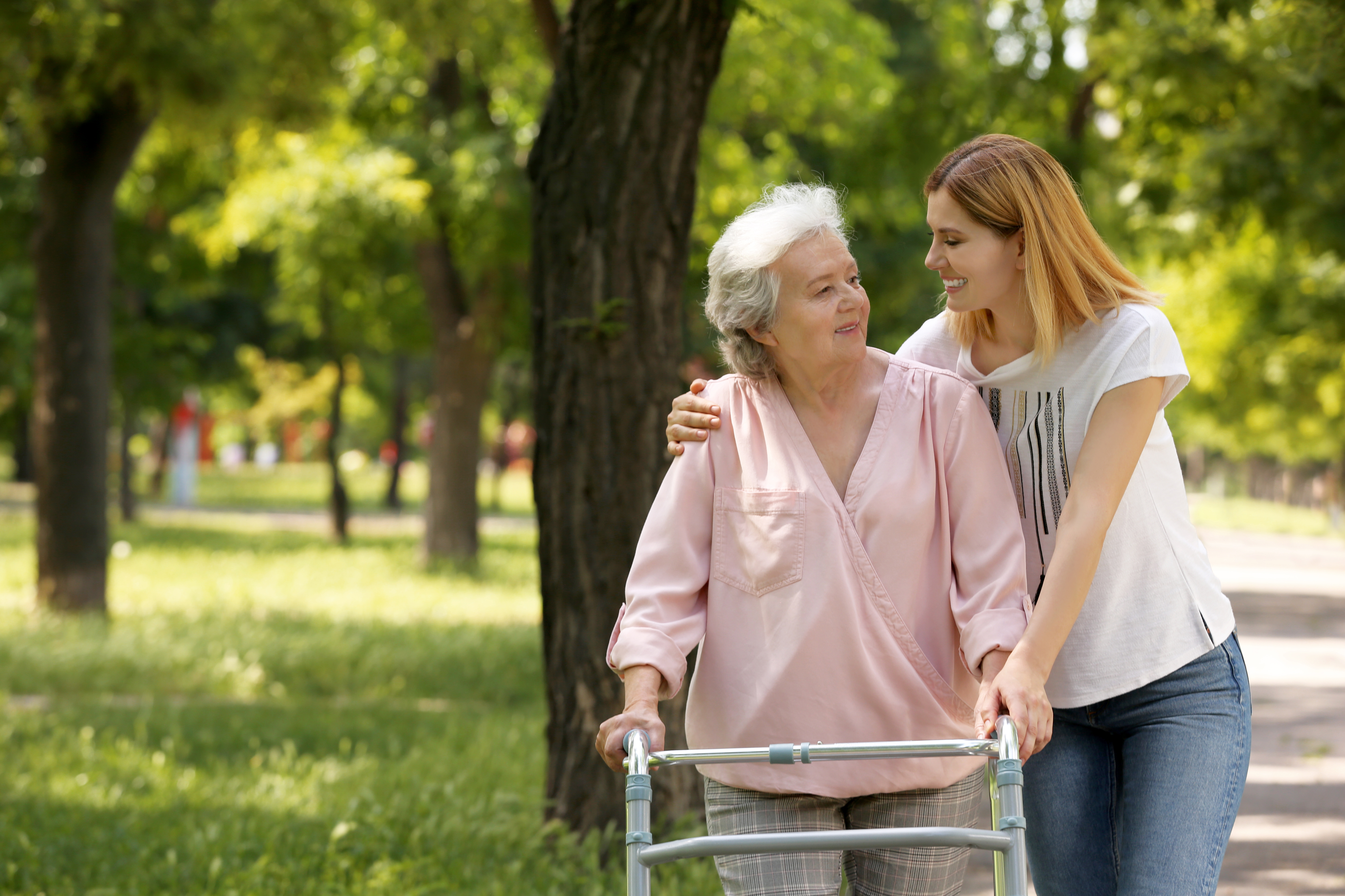 Mature parent and her child walking in park