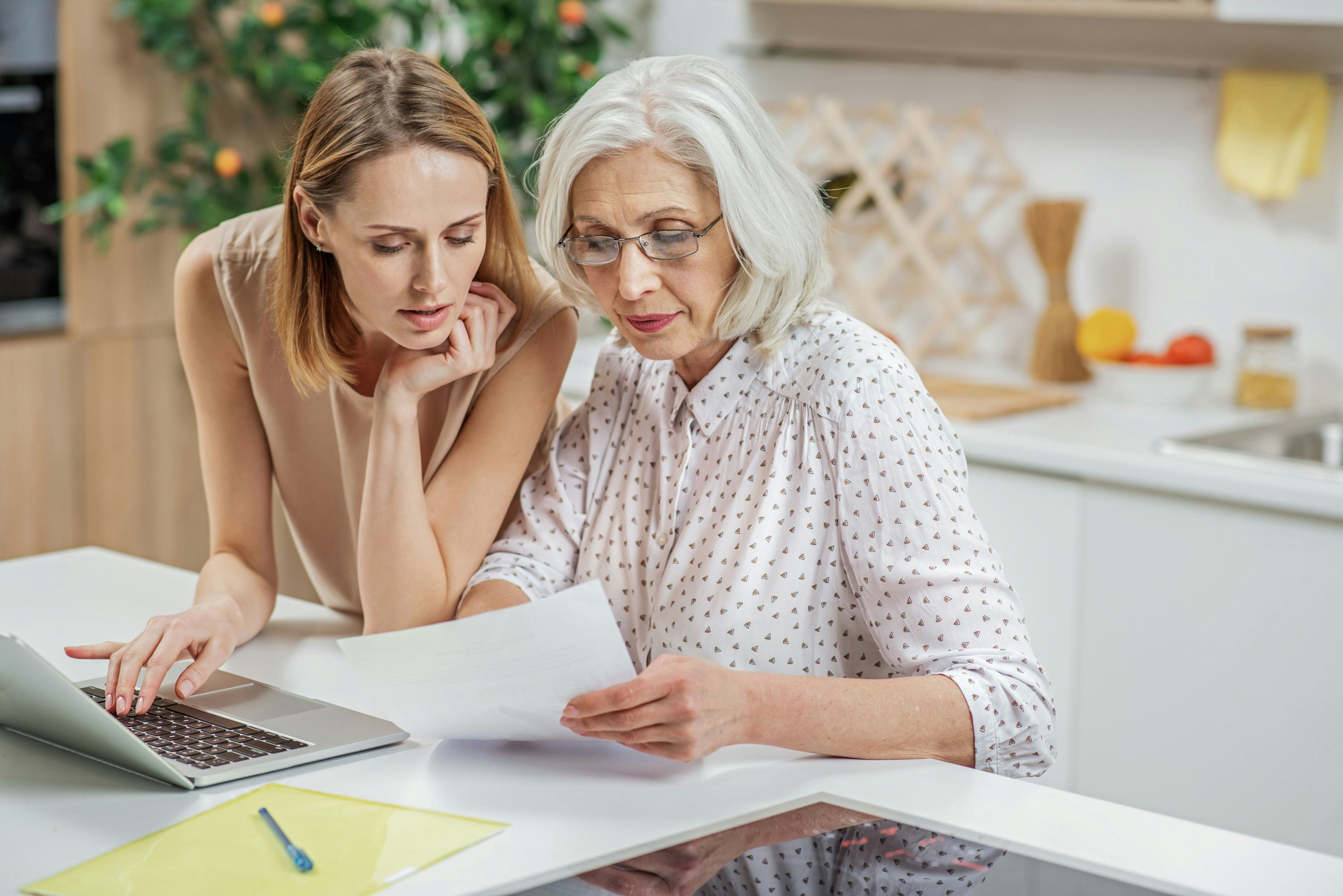 An older and younger woman going through paperwork