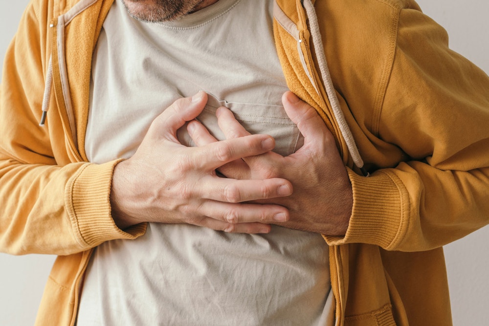 man clutching chest