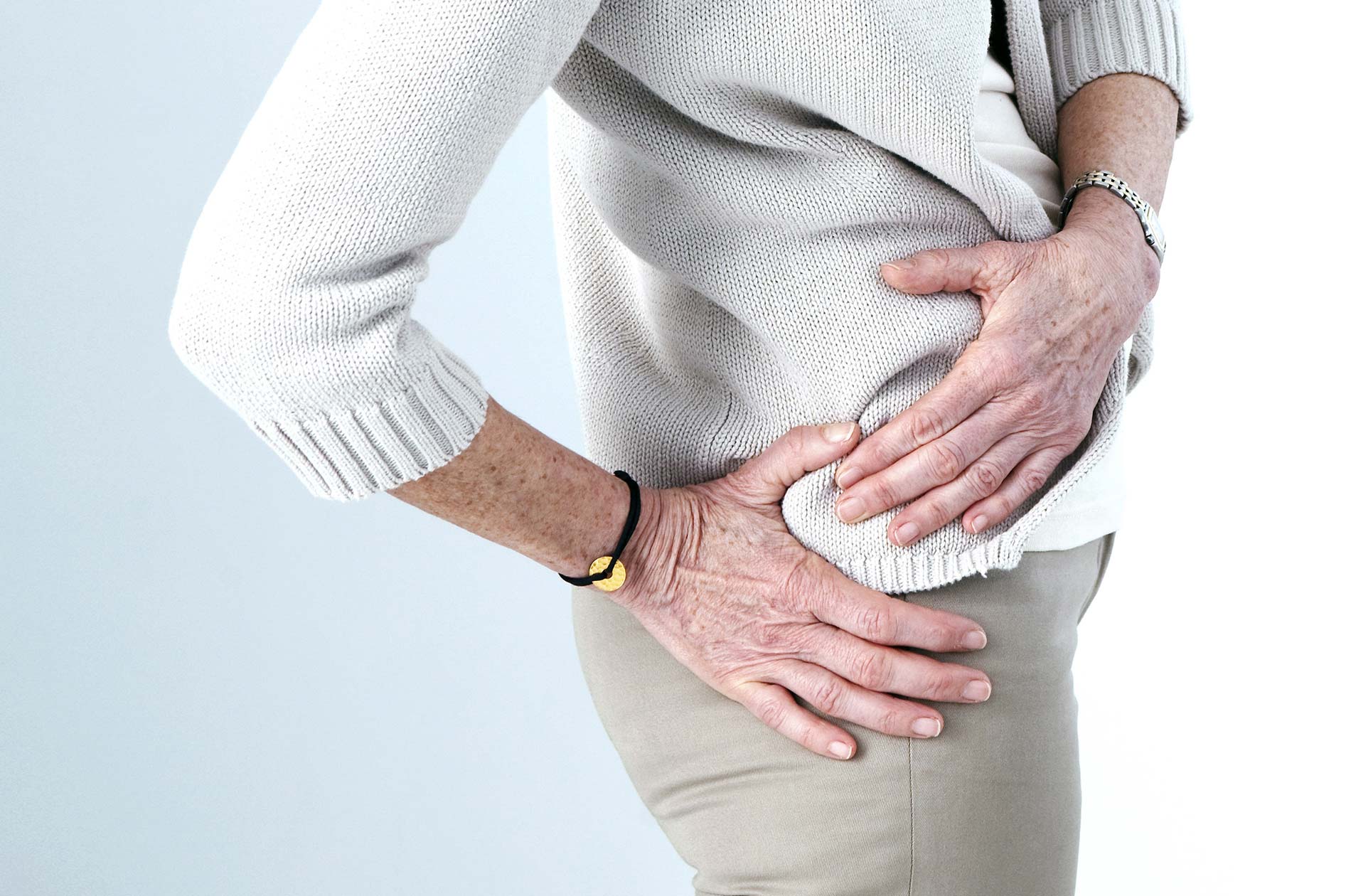 woman holding her hip in pain