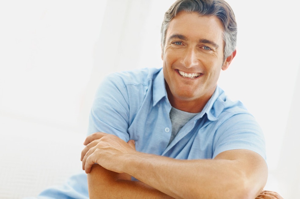 A man smiling after full mouth reconstruction.