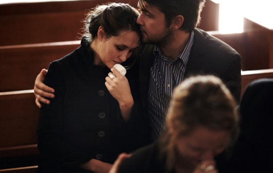 Man comforting a grieving woman