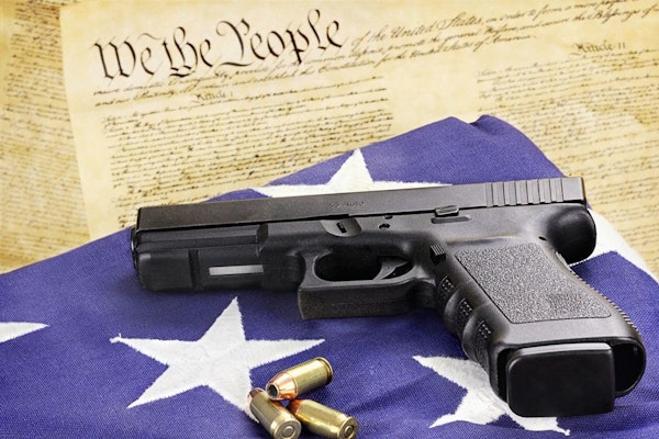 A gun, American flag, and the constitution
