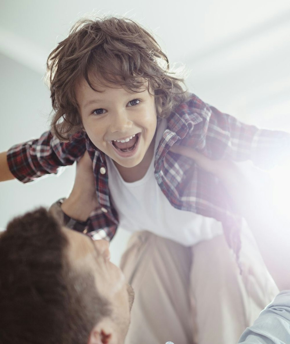 Photo of a man lifting a child