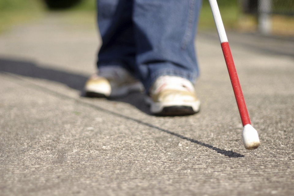 A person with a support cane