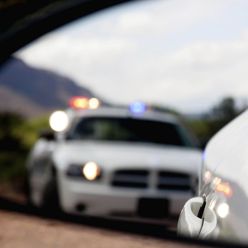 police car in rear view mirror