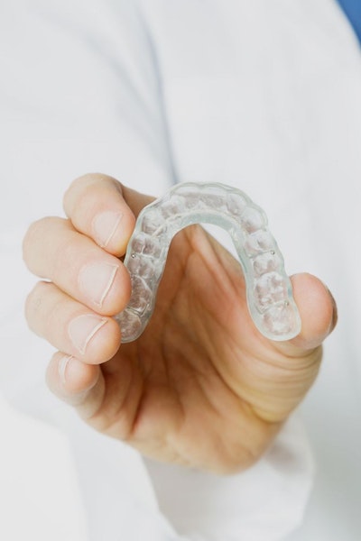 Hand holding mouthguard