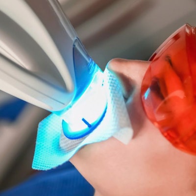someone using blue led to whiten teeth