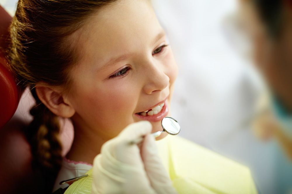 child being examined by dentist