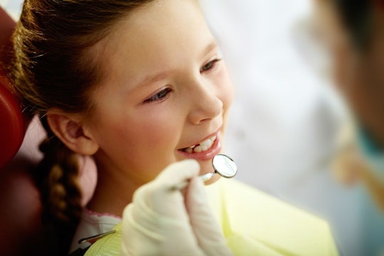 child being examined by dentist