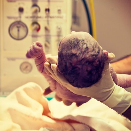 Doctor holding newborn