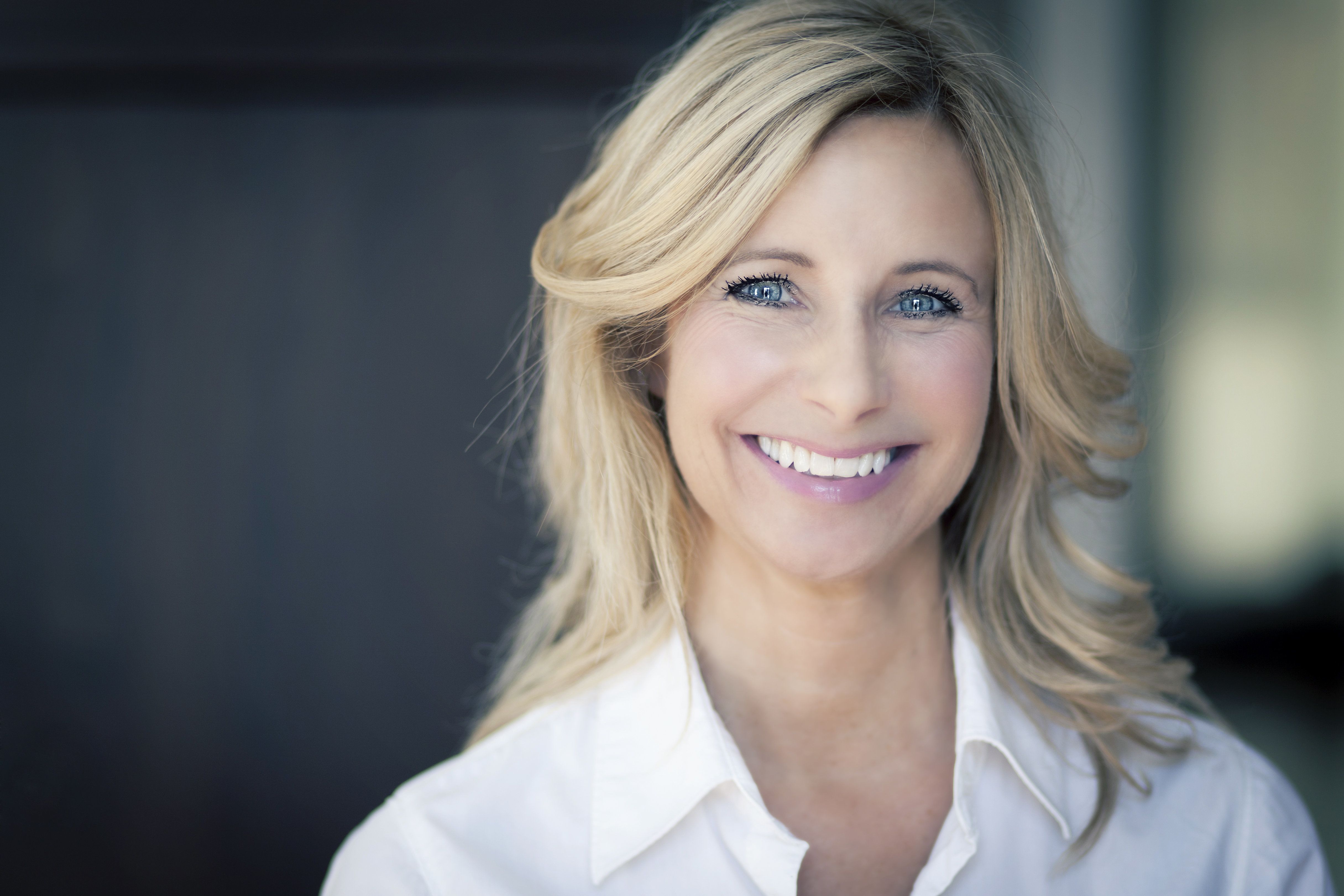 Smiling blonde woman with a white shirt