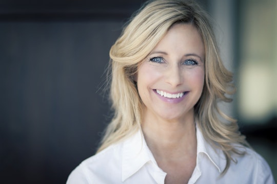 Smiling blonde woman with a white shirt