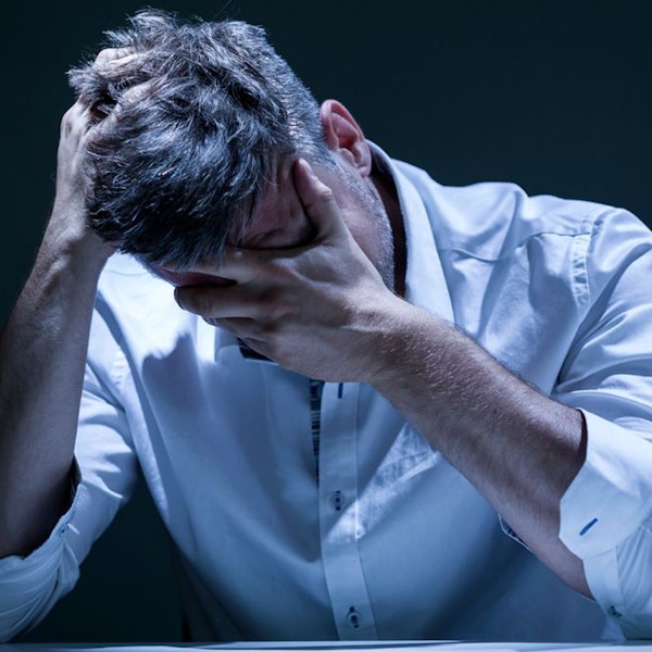 Man holding head in hands
