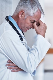 Image of doctor pinching the bridge of his nose