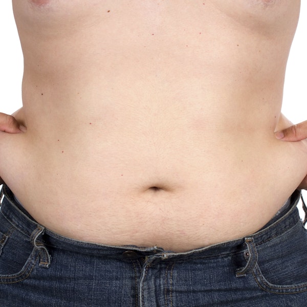 Man pinching love handles